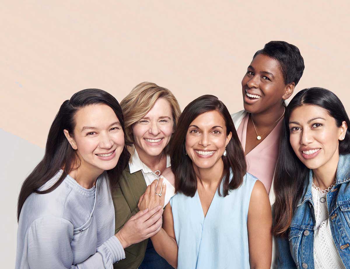 Women standing together smiling