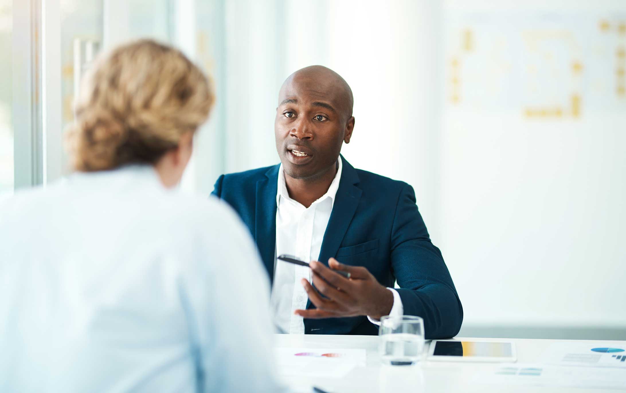 Defocused shot of a woman meeting with a professional businessman