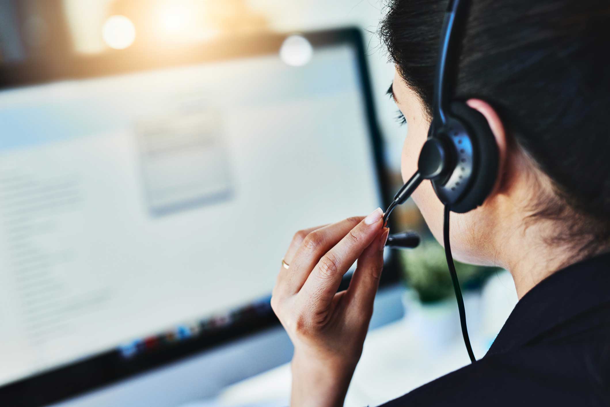 Rearview shot of a young woman working in a call center